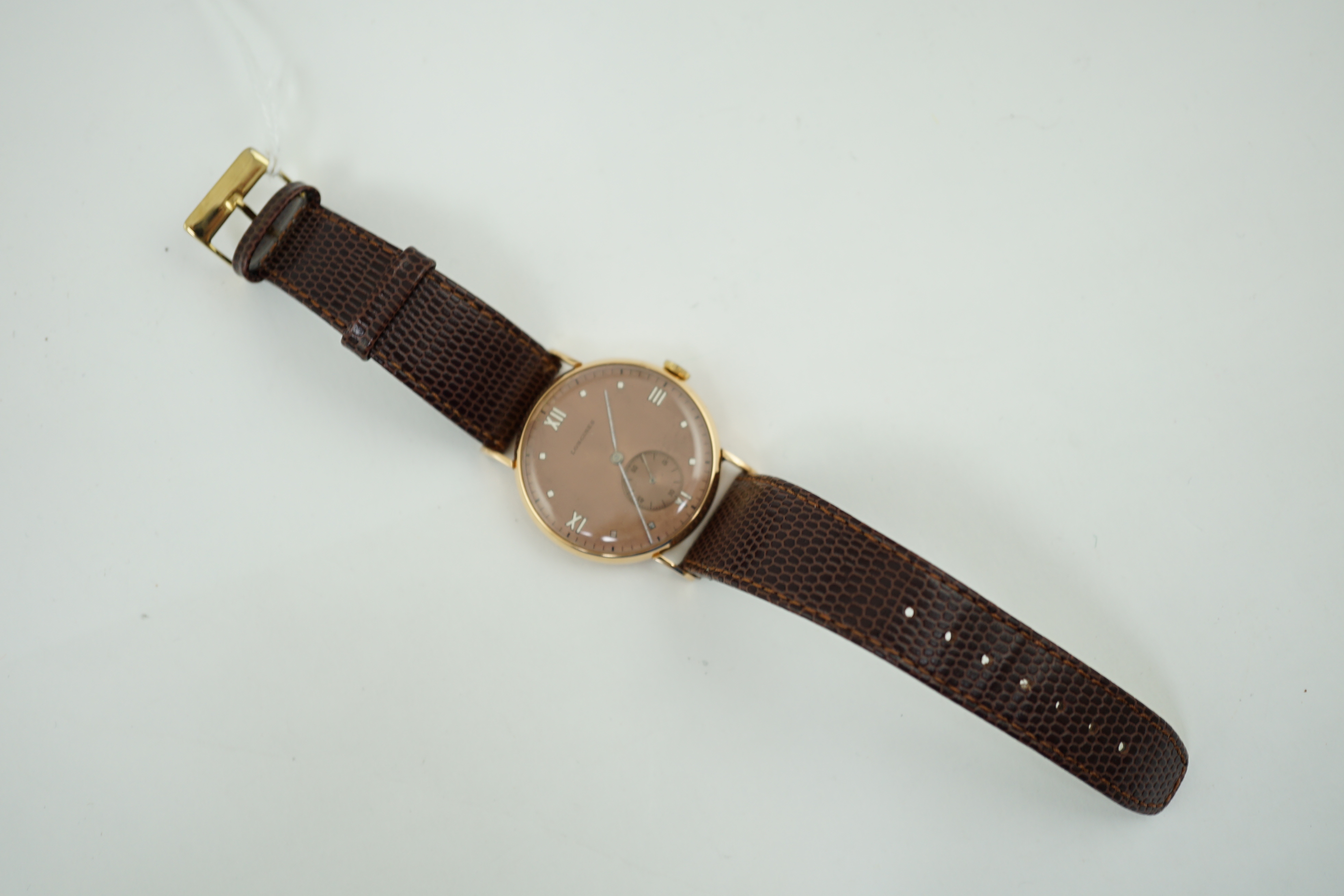 A gentleman's 1950's 18k pink gold Longines manual wind wrist watch